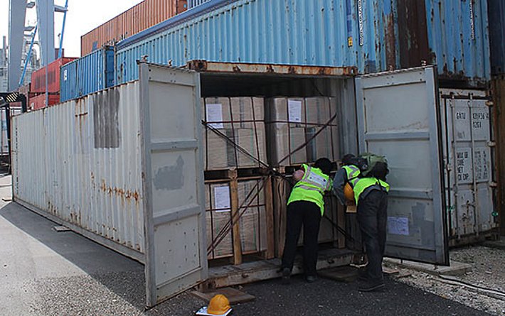 Sandra Plattner vom Bundesamt für Landwirtschaft BLW und Stefan Beyeler vom Bundesamt für Umwelt BAFU überprüfen auf einem Lagerplatz in Frenkendorf (BL) einen Container auf Käferbefall. Bild: Reinhard Lässig, WSL
